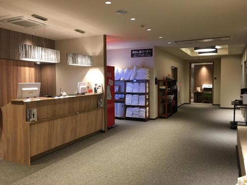 a waiting room at a pharmacy with a cashier at Hotel Crown Hills Onahama in Iwaki