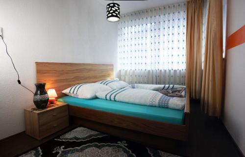 a bedroom with a bed with a large window at Alpenresorts Landeck in Landeck