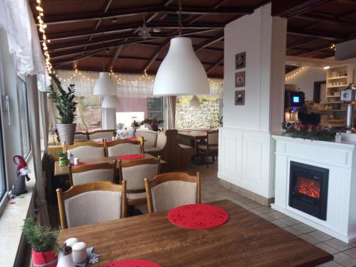 a dining room with a table and a fireplace at Landgasthaus Zu den Erdfällen in Bad Pyrmont