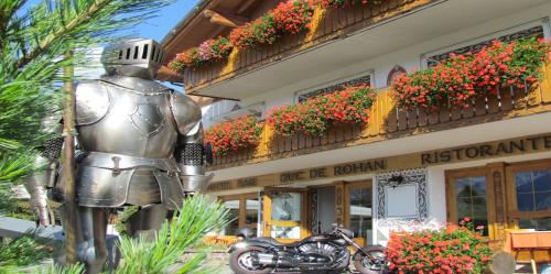 a statue of a knight standing in front of a building at Hotel Duc De Rohan in Livigno