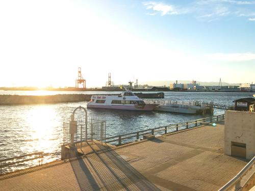 a boat docked at a dock in the water at Hotel Seagull Tenpozan Osaka in Osaka