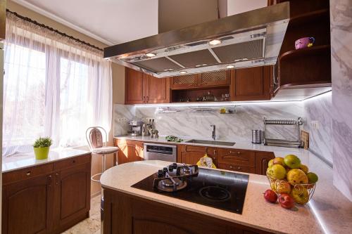 a kitchen with a sink and a bowl of fruit at Guest House Mira in Sapareva Banya