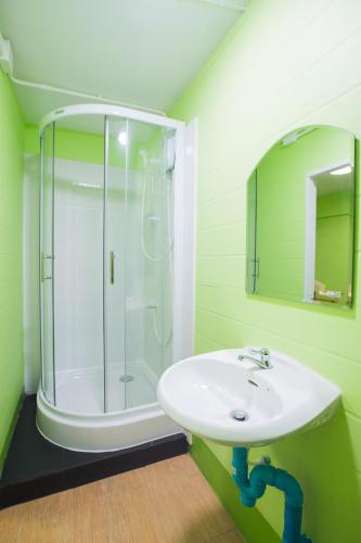 a bathroom with a sink and a shower at Your Home in Chiang Rai