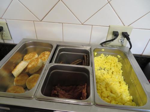 a tray of food with rice and meat and biscuits at Days Inn by Wyndham Blytheville in Blytheville