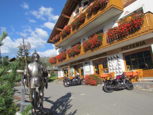 a statue of a man standing in front of a building at Hotel Duc De Rohan in Livigno