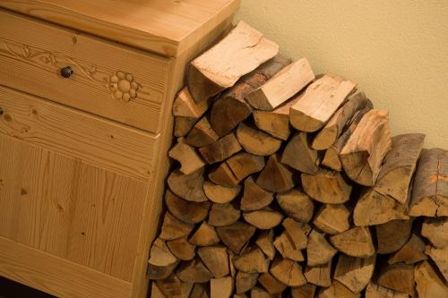 a pile of fire wood next to a wooden box at Hotel Duc De Rohan in Livigno