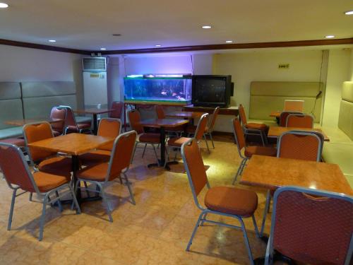 a restaurant with tables and chairs and a large aquarium at Cebuview Tourist Inn in Cebu City
