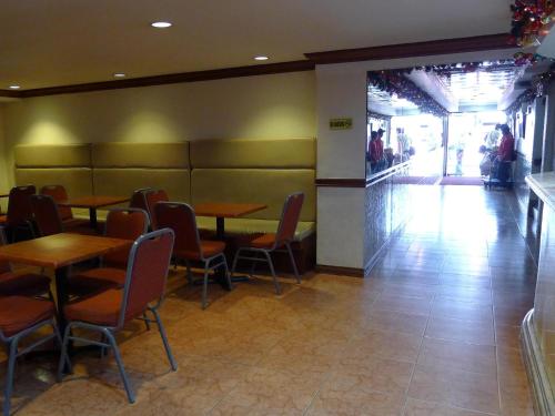 a dining room with tables and chairs in a restaurant at Cebuview Tourist Inn in Cebu City