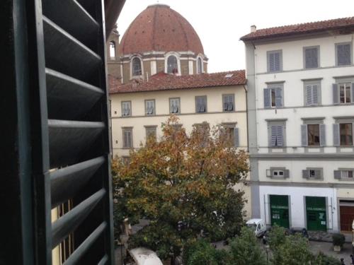 an old building with a window and a clock on it at Hotel San Lorenzo in Florence