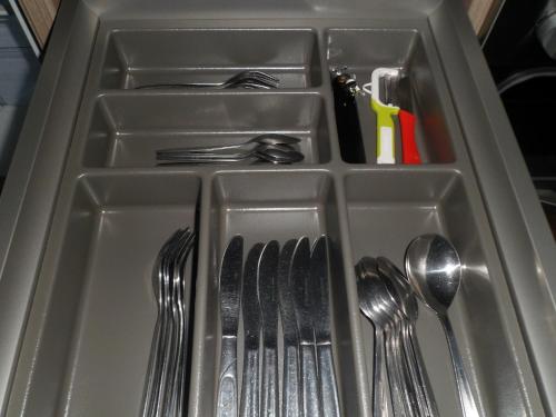 a plastic tray with forks and spoons and utensils at Berggasthaus Kraxenberger in Brannenburg