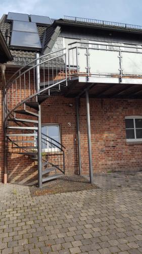 a staircase on the side of a brick building at Ferienwohnung Kirchhellen "Lepper Eck" in Bottrop-Kirchhellen