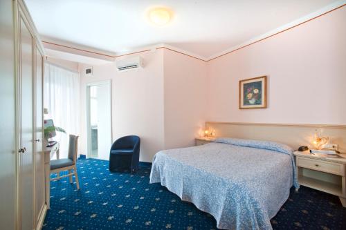 a hotel room with a bed and a desk at Terme Villa Pace in Abano Terme
