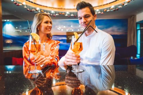 a man and a woman holding glasses of champagne at Atlantida Boutique Hotel in Rogaška Slatina