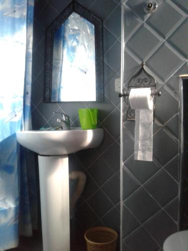 a bathroom with a sink and a mirror at Dar Lbakal in Chefchaouene