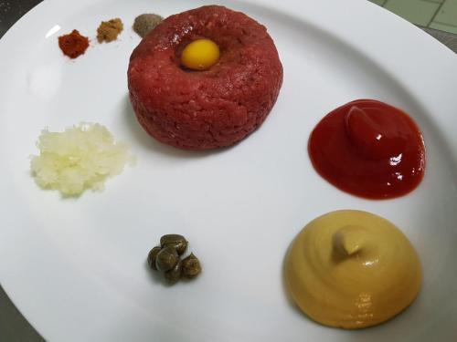 a white plate with different types of food on it at Penzion Pod Houskou in Blatce