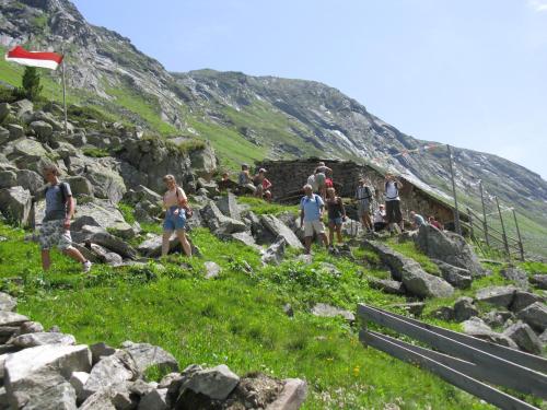 a group of people walking up a rocky mountain at Appartements Stadlerhof in Kramsach