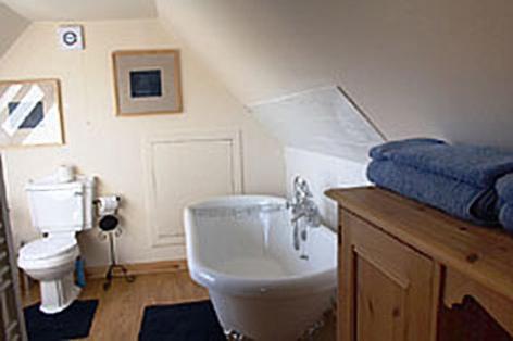 un bagno con un water bianco e un lavandino di Sealoch Cottage a Breasclete