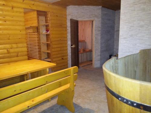 a wooden room with a wooden bench and a door at Villa Kameliya in Truskavets