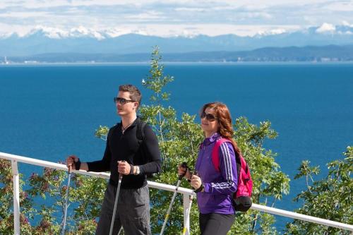 a man and a woman standing next to a railing at Floating Sea House Portorose in Portorož