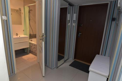 a bathroom with a shower and a toilet and a sink at Hello Warsaw! Calm Artistic City Center Apartment in Warsaw
