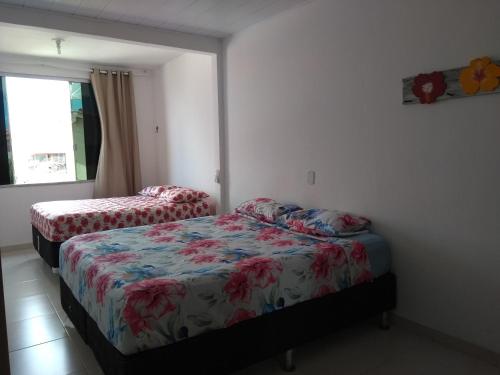 Una cama o camas en una habitación de Apartamento Thyago Porto Seguro