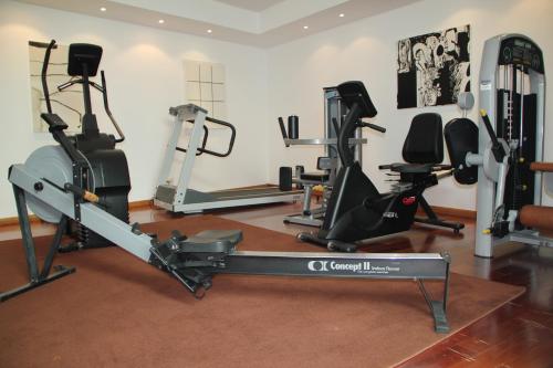 a gym with several tread machines in a room at Douro Hotel Porto Antigo in Cinfães