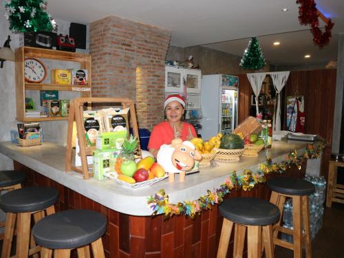 a woman standing behind a counter with fruits and vegetables at Living Chilled Koh Tao in Koh Tao