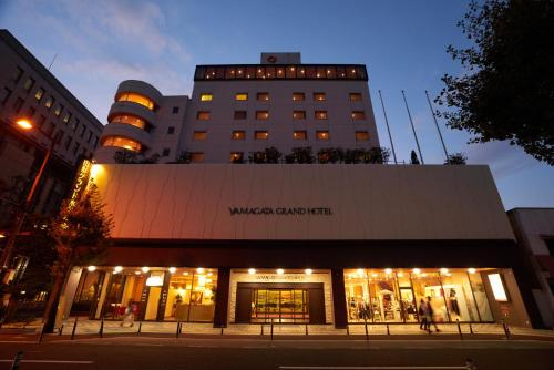 a building with a sign on the front of it at Yamagata Grand Hotel in Yamagata