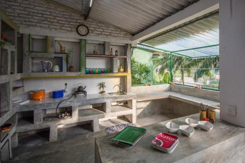 a bathroom with a sink and a large window at Udawatta Kele (UK) Forest Lodge in Kandy