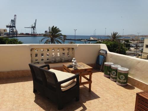 een patio met een tafel en stoelen op een dak bij Bounty Bedroom in Puerto del Rosario