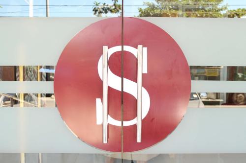 a red sign on the side of a building at Sebastien Hotel in Mactan