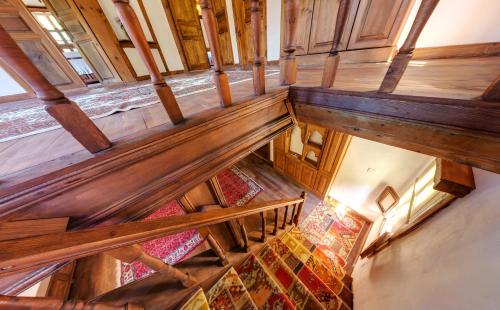 an overhead view of a staircase in a building with wooden beams at Çamlıca Konak Çarsı in Safranbolu