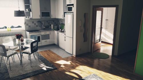 a kitchen with a table and chairs and a dining room at Apartment Dominik in Osijek