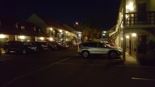 a car parked in a parking lot at night at Rose City Motel in Palmerston North
