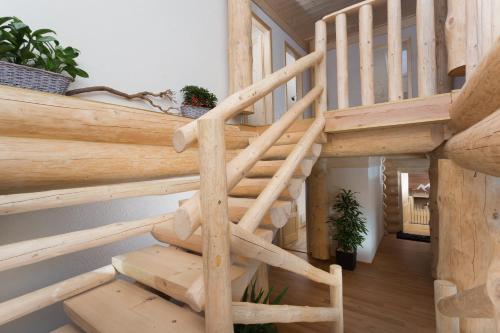 a wooden spiral staircase in a log cabin at Vysoké tatry - Tatranská Lomnica - zrub,drevenica in Tatranská Lomnica