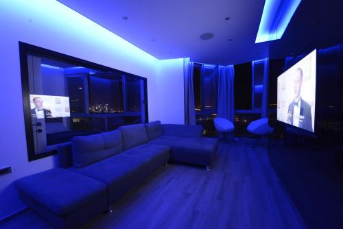 a living room with a couch and a flat screen tv at Luxury Apartment - 1335 in Bat Yam