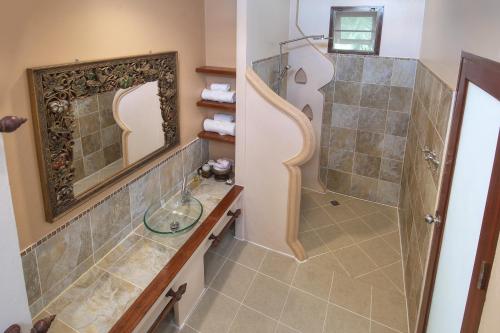 a bathroom with a shower and a mirror at Khanom Hill Resort in Khanom