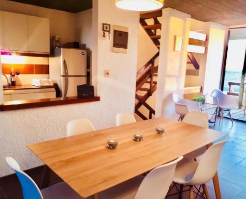 a dining room with a wooden table and chairs at Balcones del Cabito in La Paloma