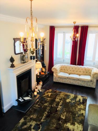 a living room with a couch and a fireplace at Camelford House in Brighton & Hove