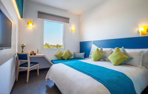 a hotel room with a large bed and a window at Relax Hotel Kenitra in Kenitra