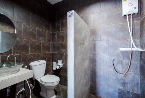 a bathroom with a shower with a toilet and a sink at Lovely Guesthouse 94 in Hua Hin
