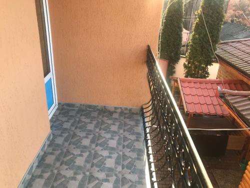 a balcony with a staircase and two chairs at Domino in Berehove