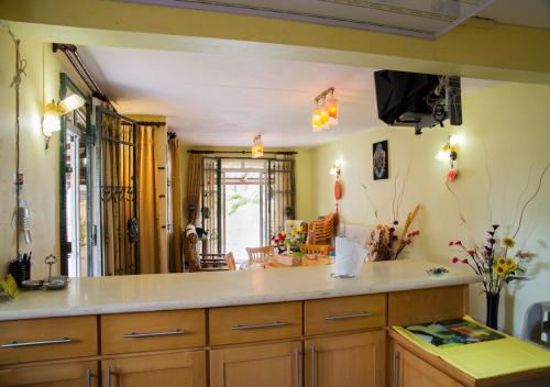 a kitchen with wooden cabinets and a counter top at Indravilla in Flic-en-Flac