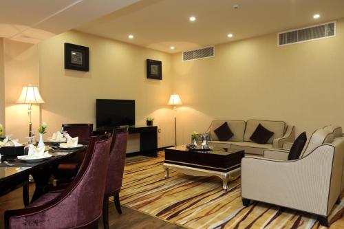 a living room with a table and a dining room at Al Muhaidb Residence Al Ahsa in Al Ahsa