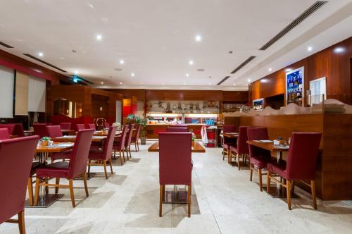 a restaurant with tables and chairs and a bar at Exe Toscana in Lucca