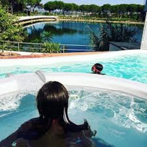 a woman sitting in a pool of water at Villaggio La Pescaccia in San Clemente