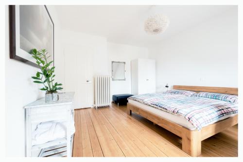 ein Schlafzimmer mit einem Bett und einer weißen Kommode in der Unterkunft Bed & Kitchen am Tavelweg - Adults Only in Bern