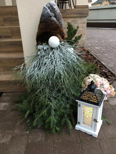 a stuffed animal is sitting on top of a plant at Kristály apartmanok in Kisvárda
