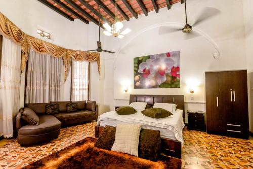 a large bedroom with a bed and a couch at Encanto Hotel Boutique in Santa Marta