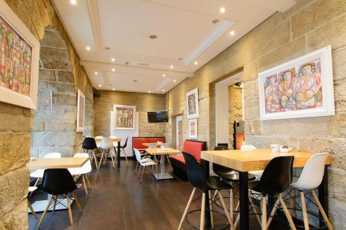 a restaurant with tables and chairs in a room at Pazo de Mendoza in Baiona